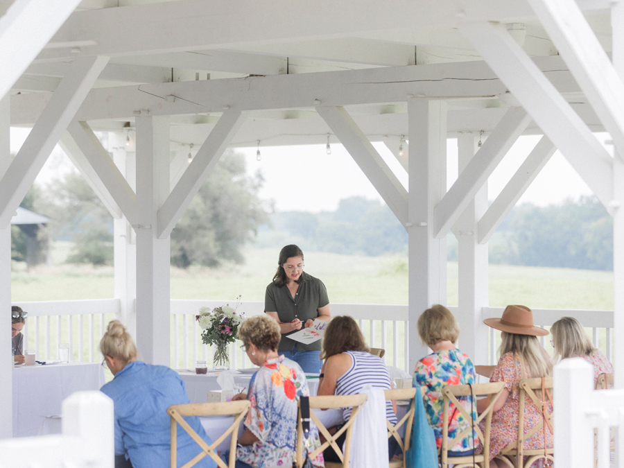 St. Louis artist Caitlin Allen instructing attendees on watercolor techniques at the Blue Bell Farm paint and picnic event.