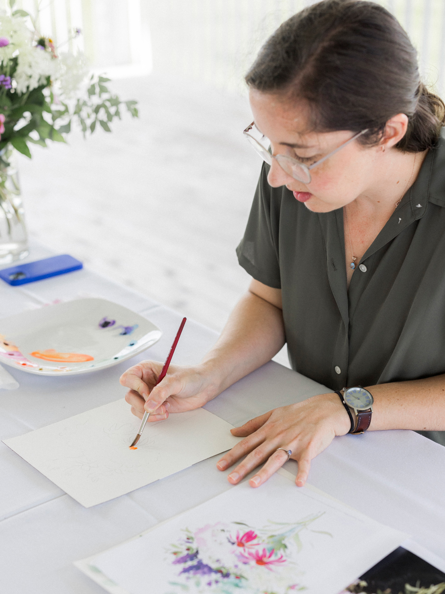 Close-up of a Caitlin Allen's watercolor painting in progress, highlighting the creative spirit of the Blue Bell Farm paint and picnic event.