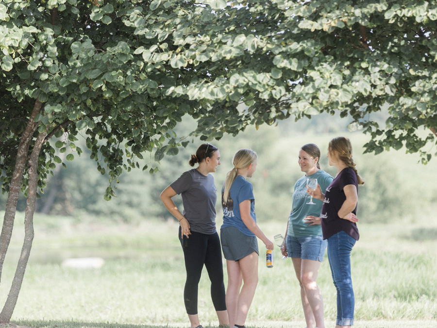 Attendees enjoying their picnic lunch from Beet Box, with the scenic Blue Bell Farm landscape in the background.