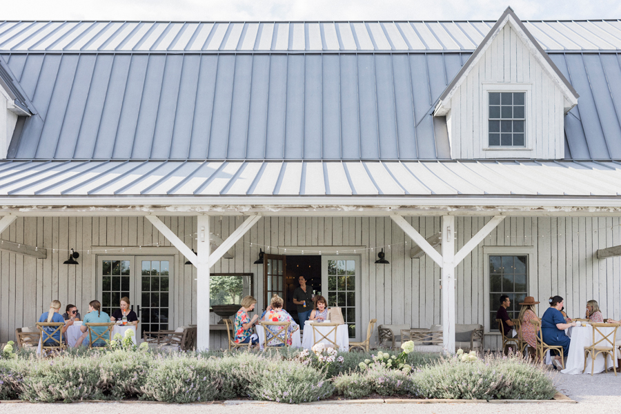 Attendees enjoying their picnic lunch from Beet Box, with the scenic Blue Bell Farm landscape in the background.