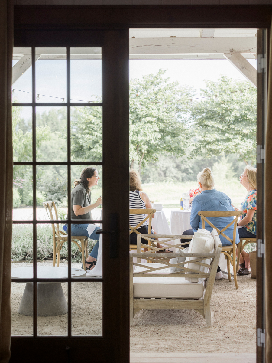 Attendees enjoying their picnic lunch from Beet Box, with the scenic Blue Bell Farm landscape in the background.