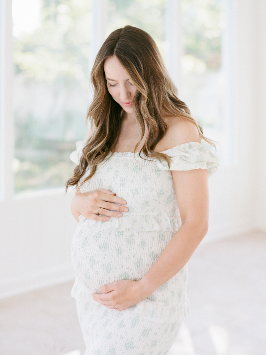 Expectant mother posing solo in a dreamy Columbia, Missouri, Garden Studios during her family maternity session by Love Tree Studios.