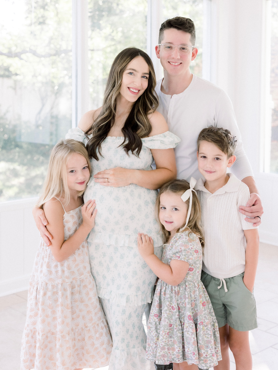 Family of five joyfully anticipating their new arrival, posing together in coordinated outfits during a family maternity session at Love Tree Studio's Garden Studio in Columbia, MO.