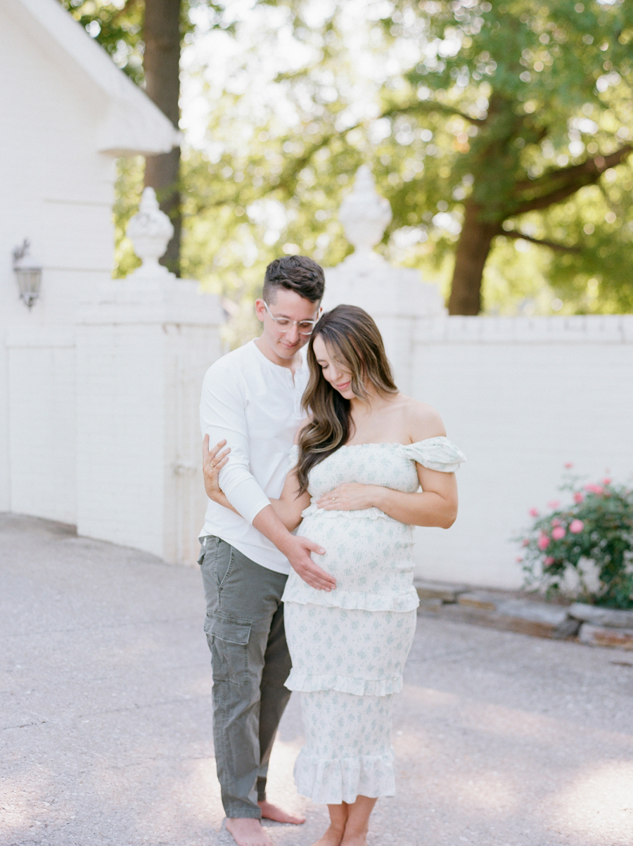 The Bedford family sharing a tender moment in a Columbia, Missouri Garden Studio during their family maternity session with Love Tree Studios.