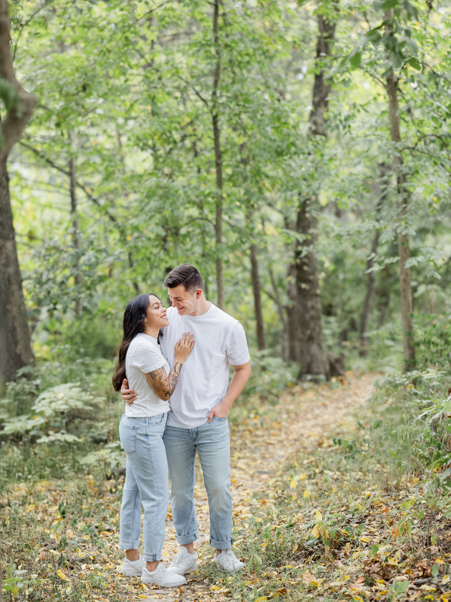 Bryanna and Chase wearing matching white t-shirts and jeans during their candid engagement session.