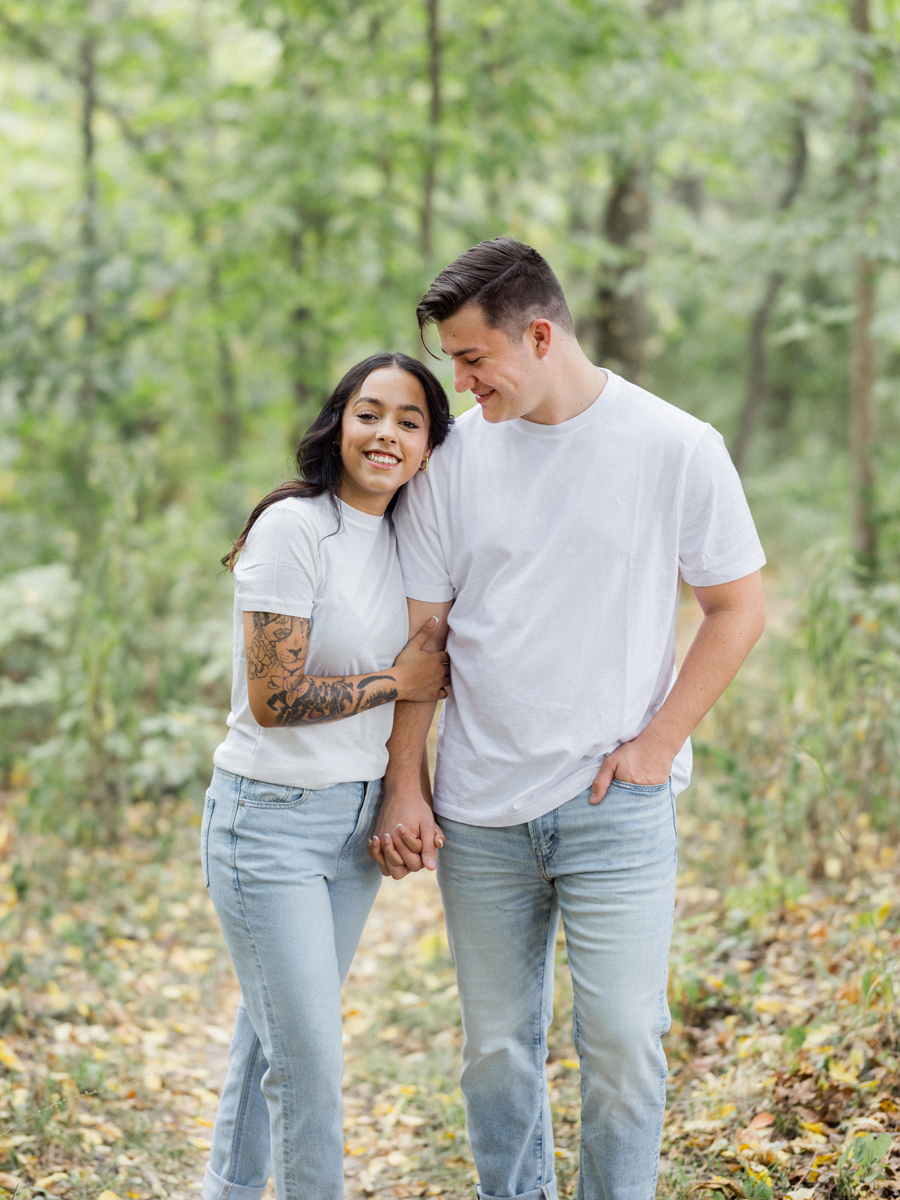 Candid shot of Bryanna and Chase in a wooded trail.