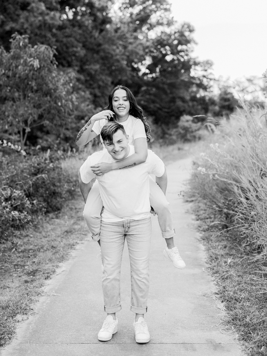 Couple enjoying a candid moment in a Missouri field.