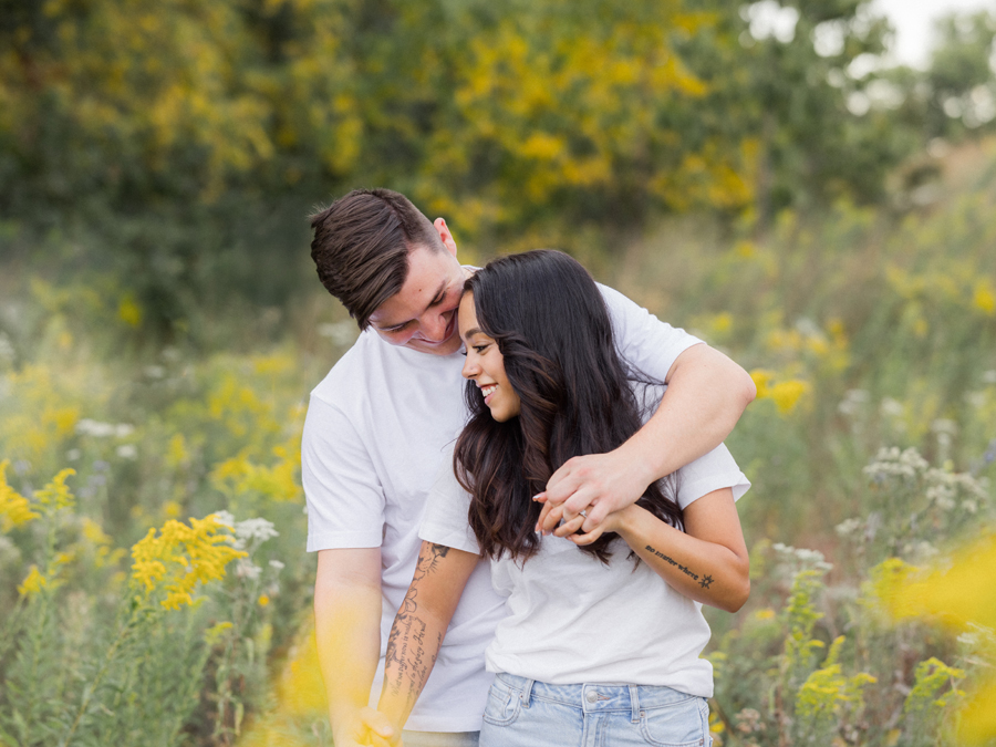 Bryanna and Chase smiling in a sunlit Missouri field.