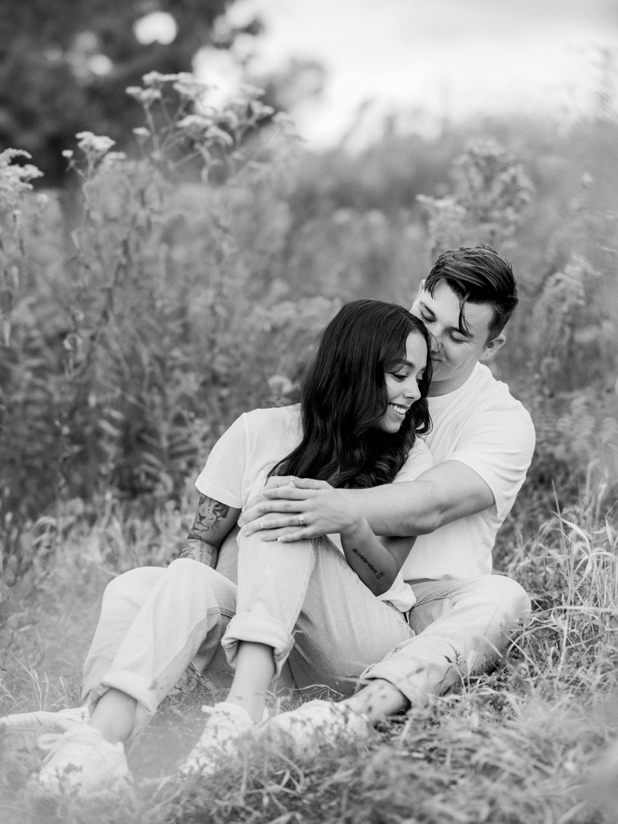 Natural, candid moment of Bryanna and Chase sitting in the grass.