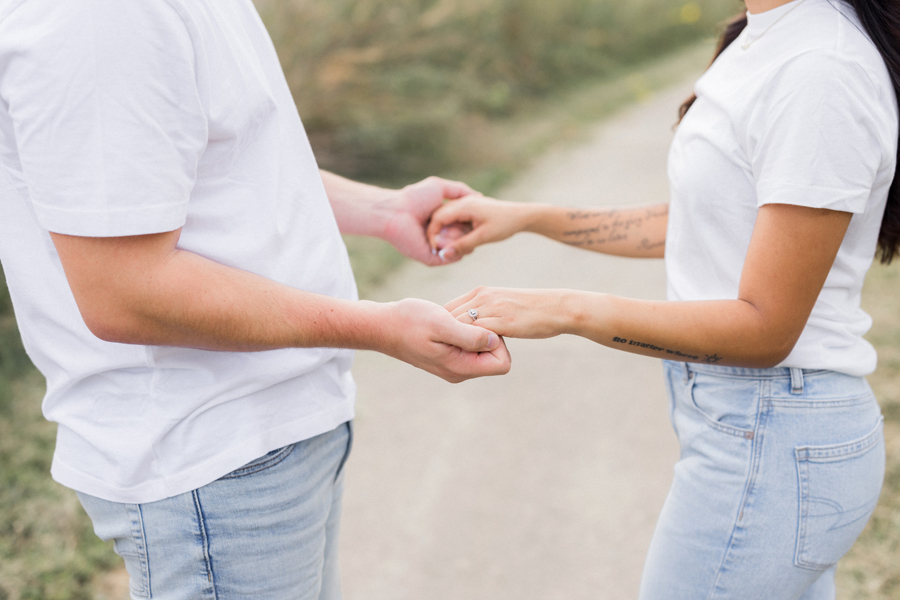 Natural moment of Bryanna and Chase holding hands in their engagement session.