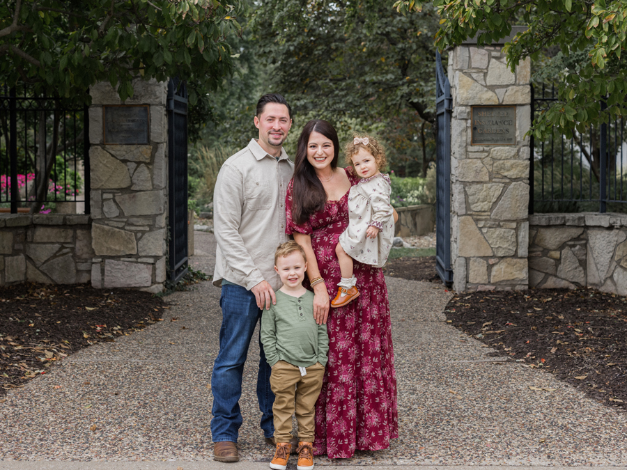 The Bahner family smiling together outdoors during their Missouri family session.