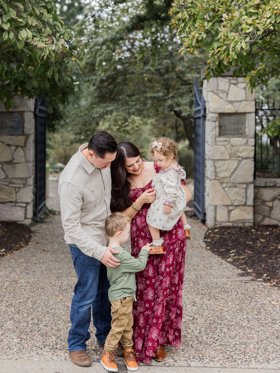 The family sharing a candid moment, laughing and enjoying each other’s company.