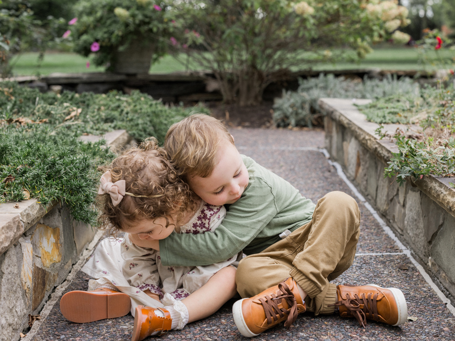 Macklin leaning in close to Mariah, sharing a sweet brother-sister moment.