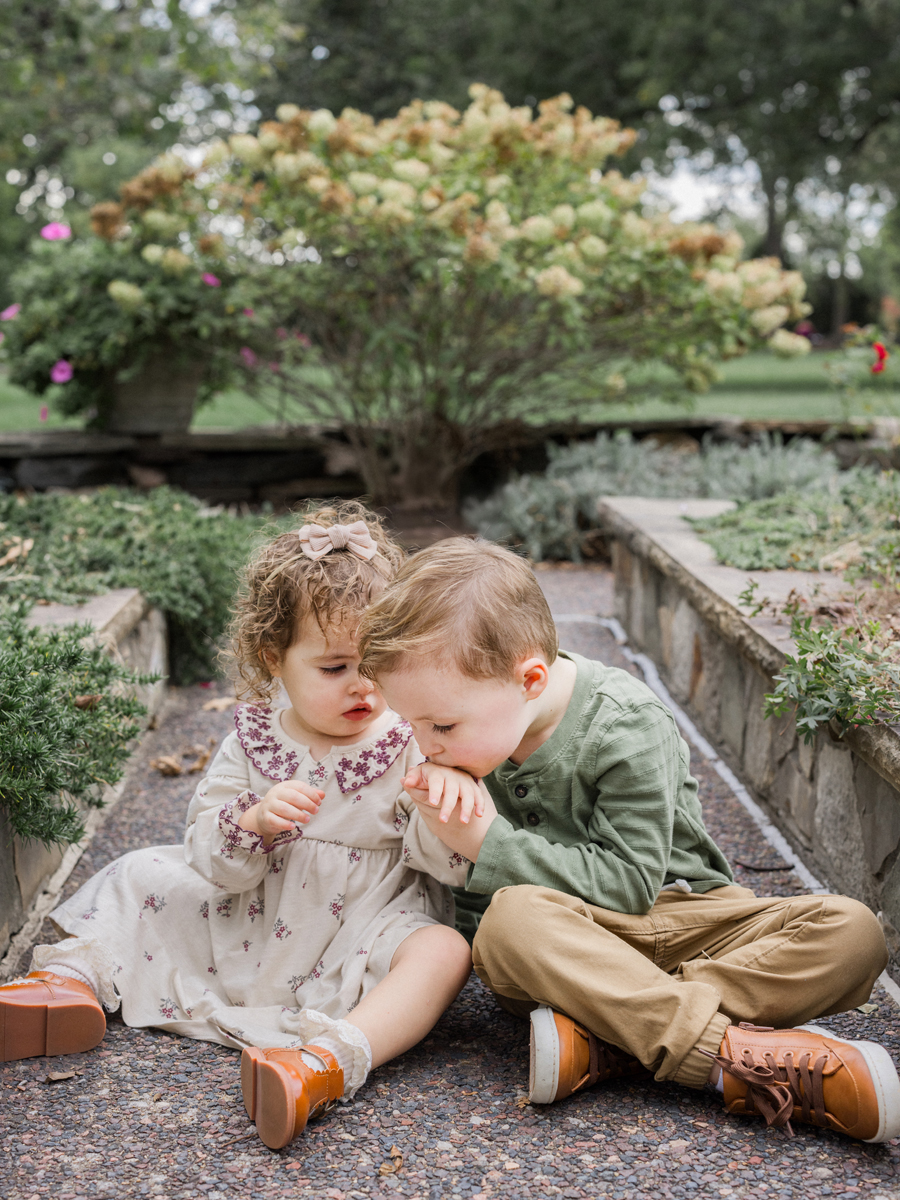 Macklin kisses Mariah's hand, showing he is kind big brother.