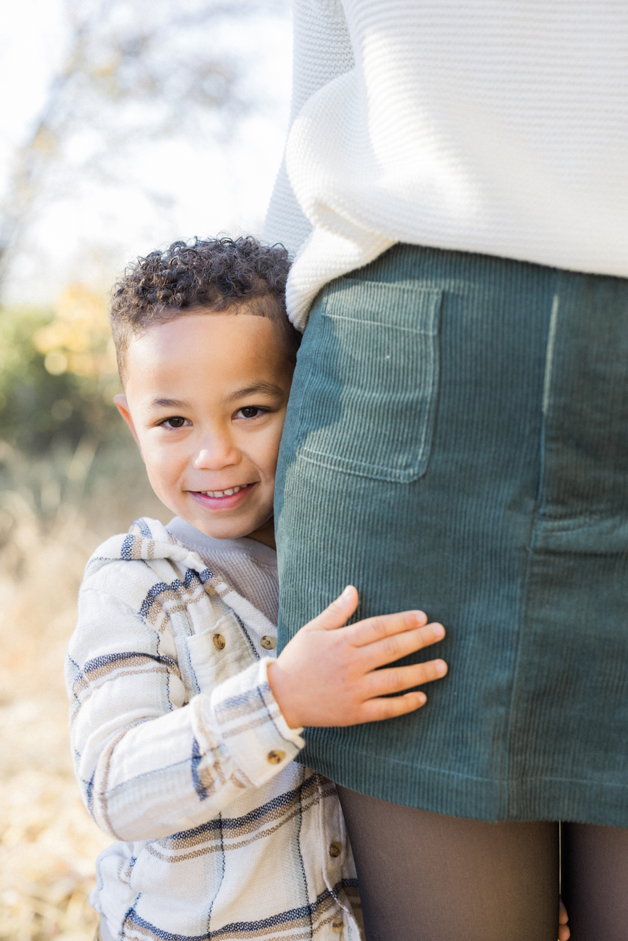 Myles hugging Mom in the soft evening light at Pierpont Farms Family Session, photographed by Love Tree Studios.