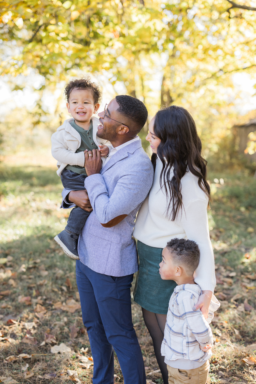 Dad tossing Myles in the air at Pierpont Farms Family Session, a joyful moment captured by Love Tree Studios.