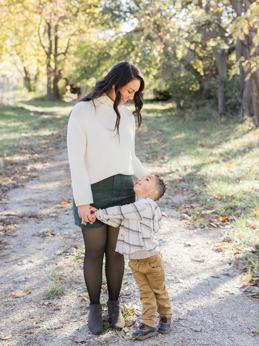 Mom smiling as she walks hand-in-hand with Myles at Pierpont Farms Family Session, photographed by Love Tree Studios.