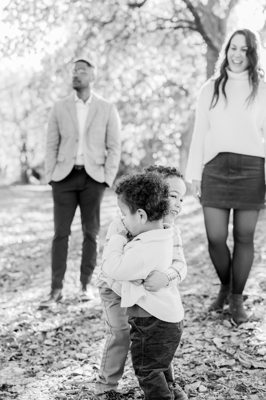 Myles and Theo hugging each other in the soft evening light at Pierpont Farms Family Session, photographed by Love Tree Studios.