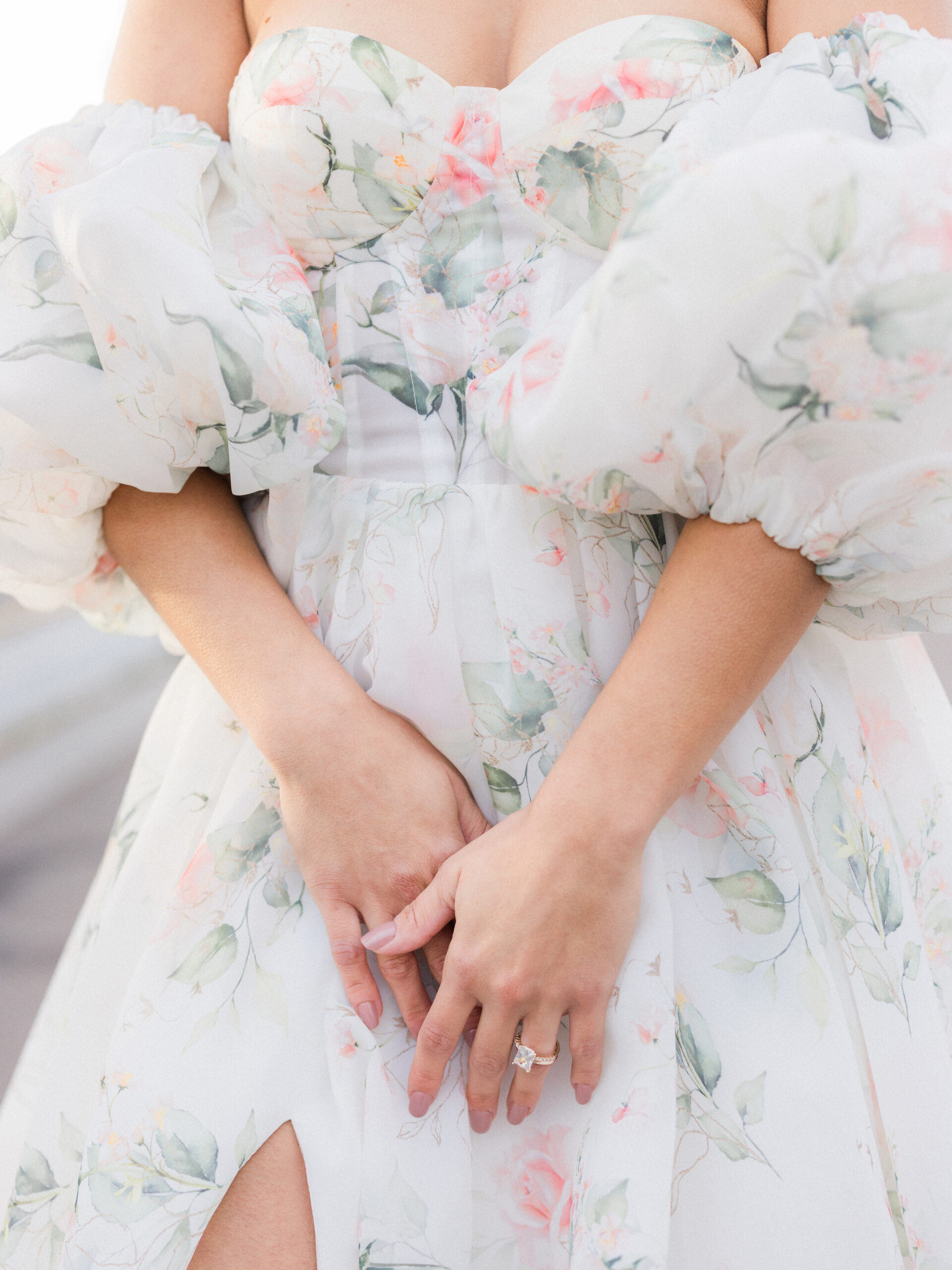 Sinaï crosses her hands over her floral dress on the Pont Alexandre III Bridge Love Tree Studios.