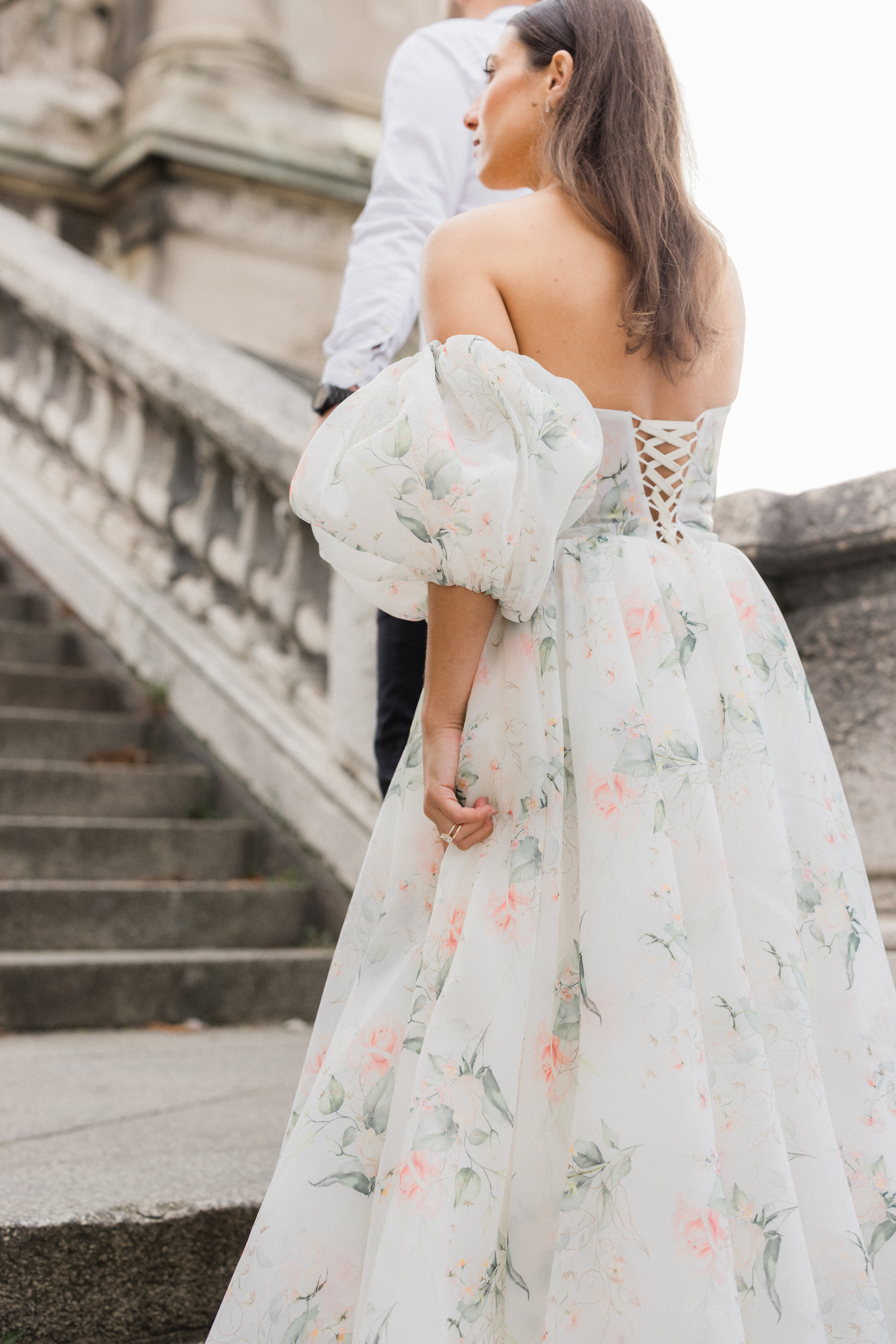 Close-up of Abraham helping Sinaï step carefully up the bridge steps, capturing their connection in a candid moment Love Tree Studios.