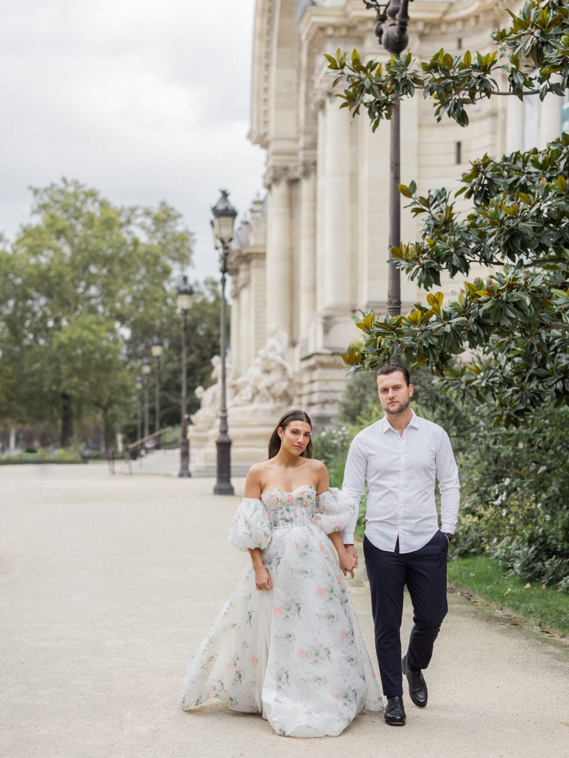 Sinaï and Abraham walking hand in hand by La Petite Palace’s grand entrance.