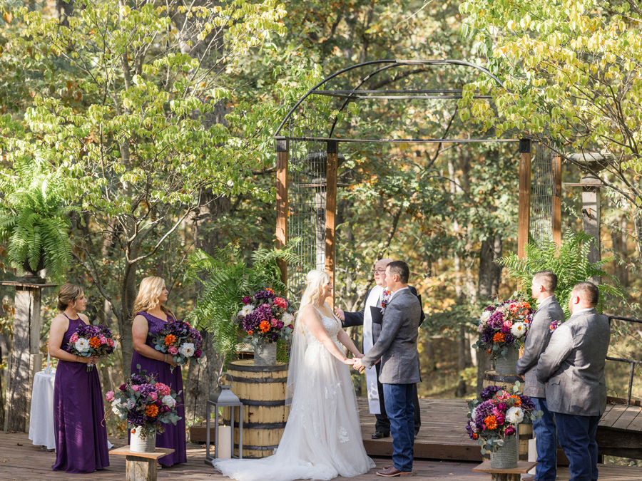 The wedding ceremony at Alpine Park and Gardens with rustic and elegant decor, a perfect chic Western Missouri wedding moment by Love Tree Studios.