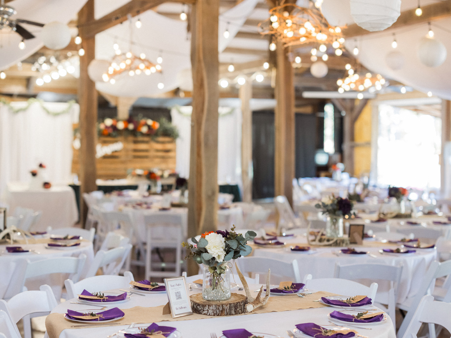 Rustic tablescape with vibrant florals at a chic Western Missouri wedding reception, captured by Love Tree Studios.