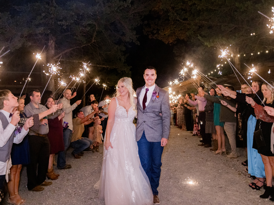 Bride and groom's sparkler exit at their chic Western Missouri wedding, captured by Love Tree Studios.