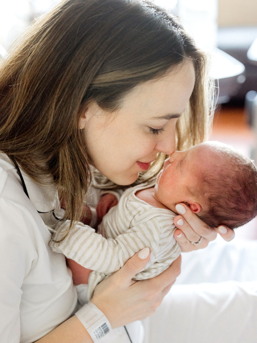 Stunning photo of pa mother gazing at her newborn, celebrating the joy of a Fresh 48 session.