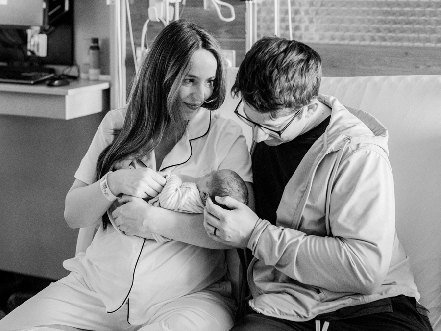 Black and white image of a family’s first moments with their newborn, documenting the beauty of a Fresh 48 session.