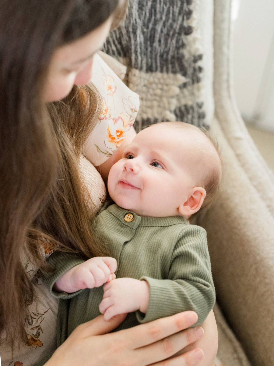 Baby Corbin Wesley smiling during an in-home Columbia newborn photography session by Love Tree Studios.