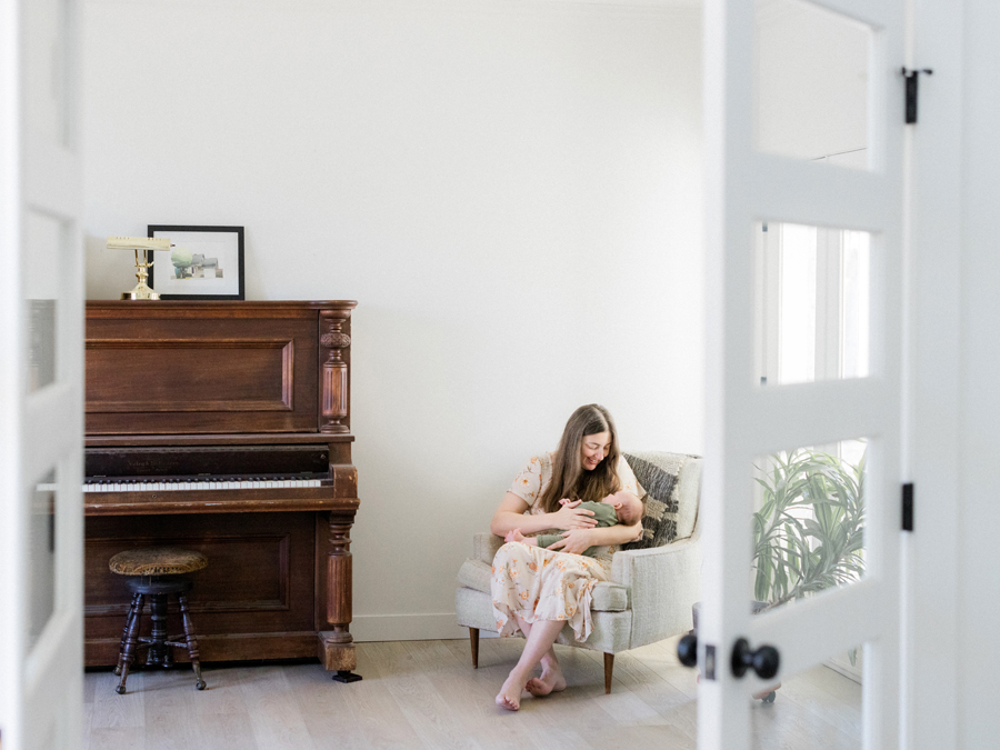 Mother and baby Corbin Wesley sharing a quiet moment during an in-home session by Love Tree Studios.