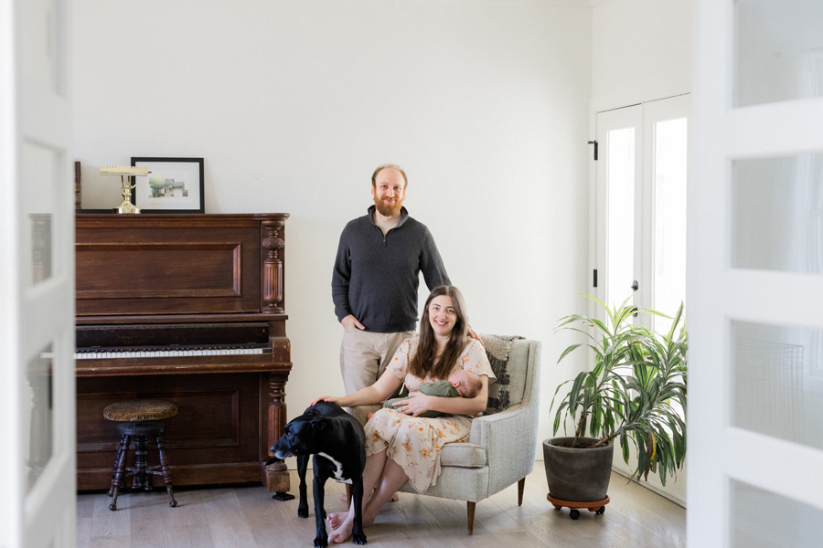 Family portrait featuring baby Corbin Wesley and Charlie the dog during a newborn session by Love Tree Studios.