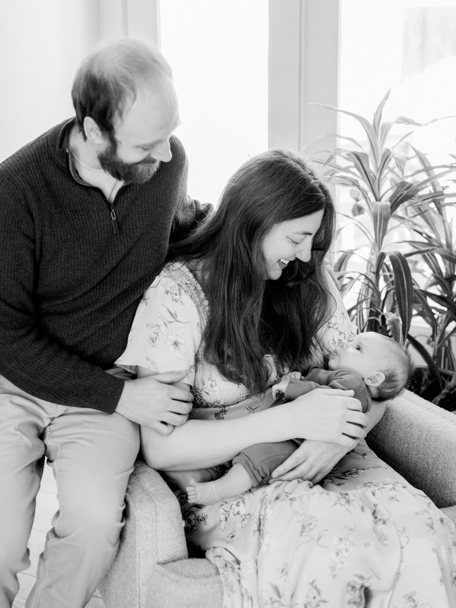 Parents holding baby Corbin Wesley in a cozy Columbia newborn photography shoot by Love Tree Studios.