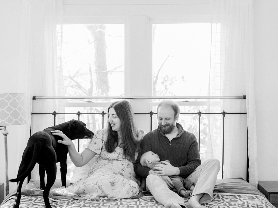 Charlie the dog and baby Corbin Wesley sharing a sweet moment during an in-home session by Love Tree Studios.