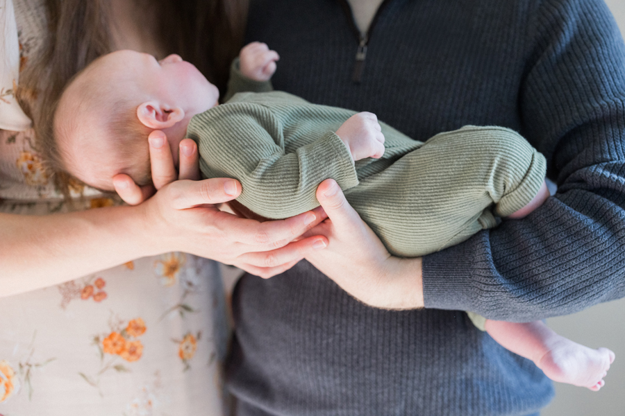 Father holding baby Corbin Wesley by the nursery window during a Columbia newborn photography shoot.