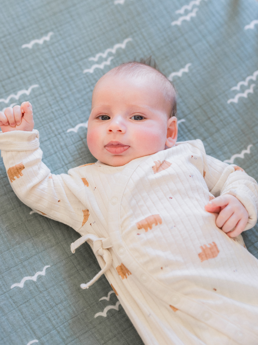 Baby Corbin Wesley lying peacefully in his nursery during a Columbia newborn photography session by Love Tree Studios.