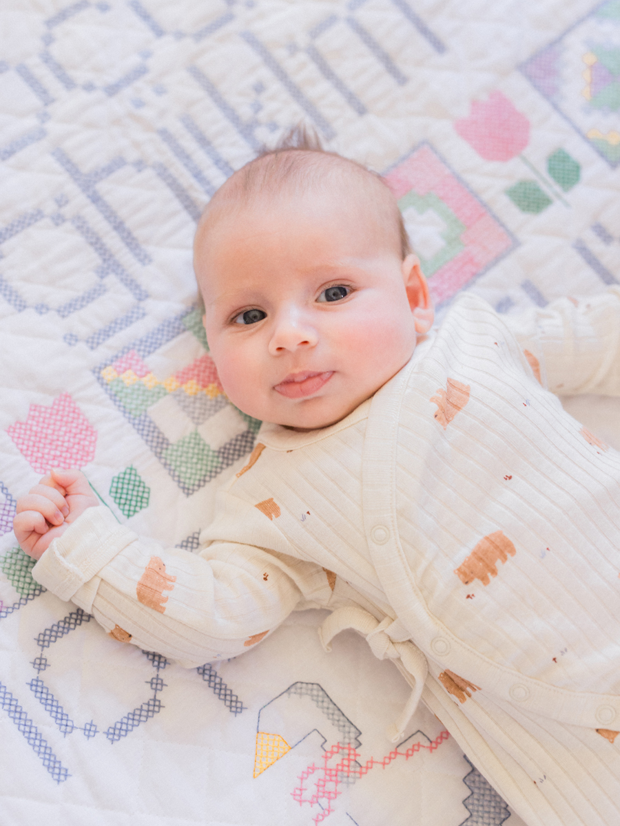 Baby Corbin Wesley lying on a soft blanket in his nursery, captured by Love Tree Studios in Columbia, MO.