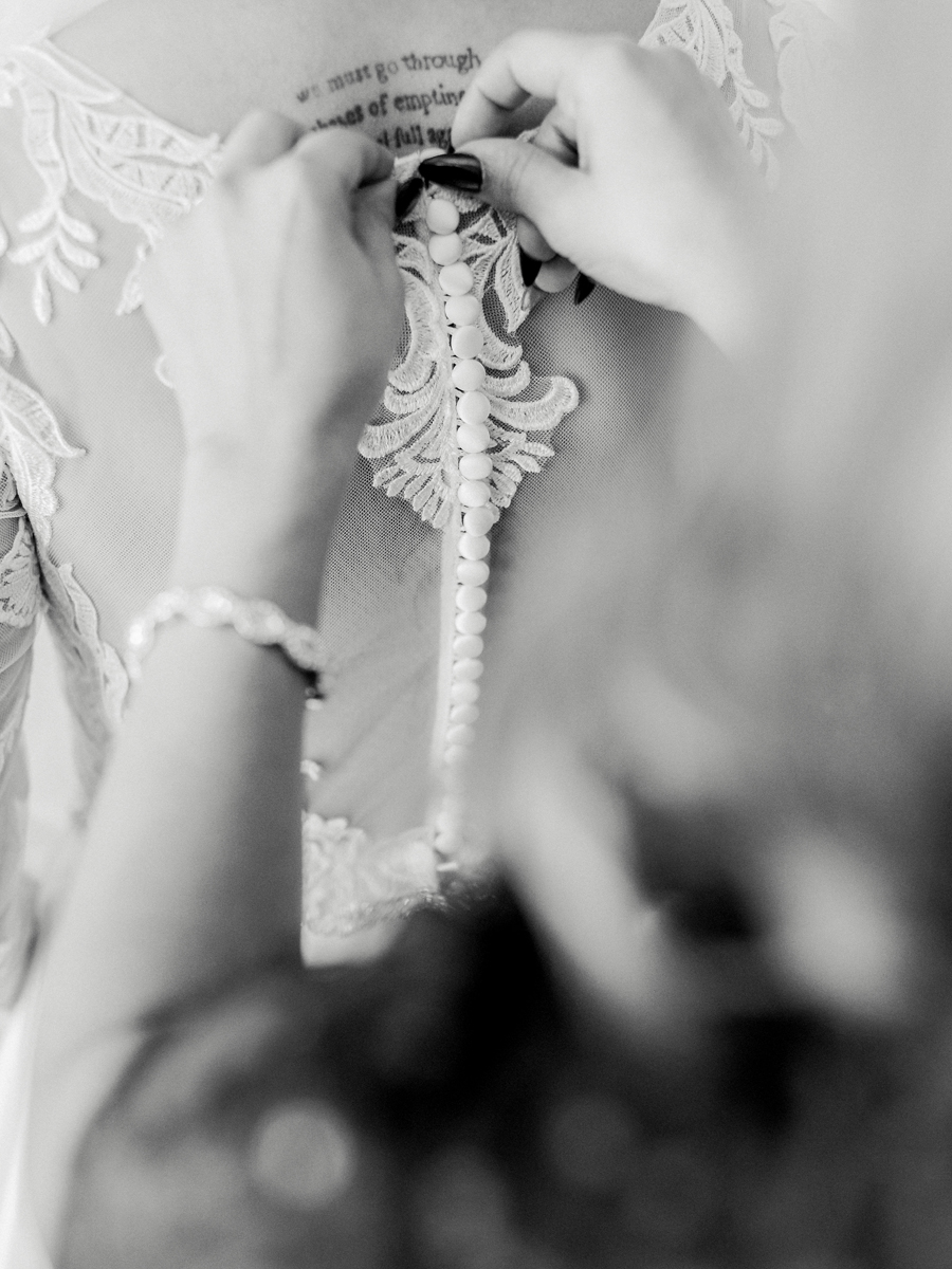 Bryanna’s mom helping her with her dress at Cooper's Ridge Wedding Venue, captured by Love Tree Studios.