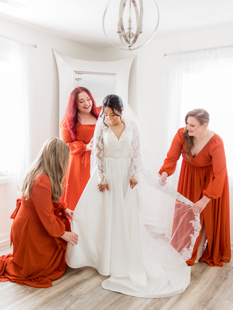 Candid moment of Bryanna laughing with her bridesmaids while getting ready at Cooper's Ridge Wedding Venue, captured by Love Tree Studios.