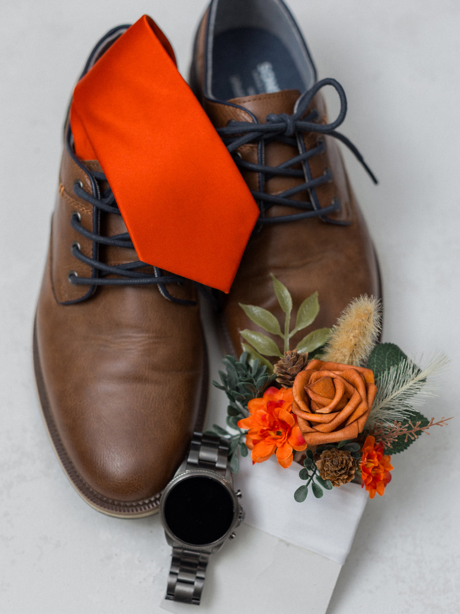 The groom’s shoes and boutonniere captured during getting-ready moments at Cooper's Ridge Wedding Venue, photographed by Love Tree Studios.