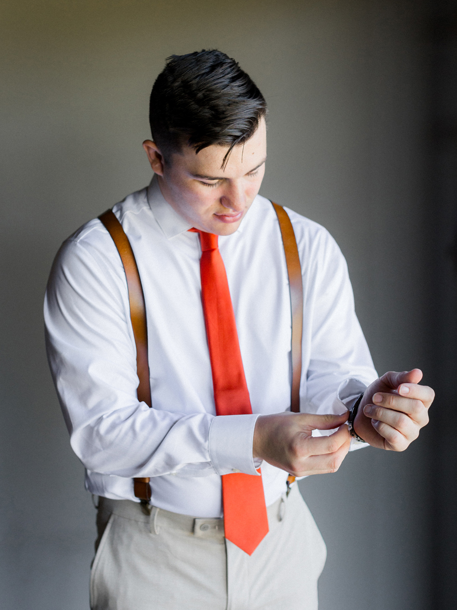 Chase adjusting his watch before the ceremony at Cooper's Ridge Wedding Venue, photographed by Love Tree Studios.