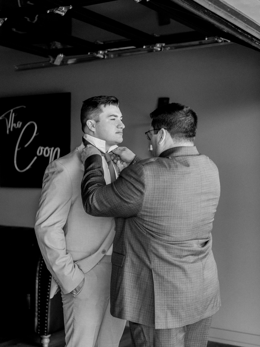 Candid moment of Chase with his dad getting ready at Cooper's Ridge Wedding Venue, photographed by Love Tree Studios.