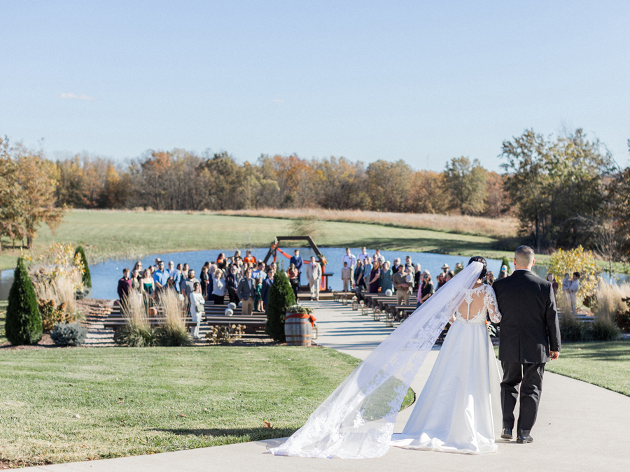 Bryanna walking down the aisle at Cooper's Ridge Wedding Venue, captured by Love Tree Studios.