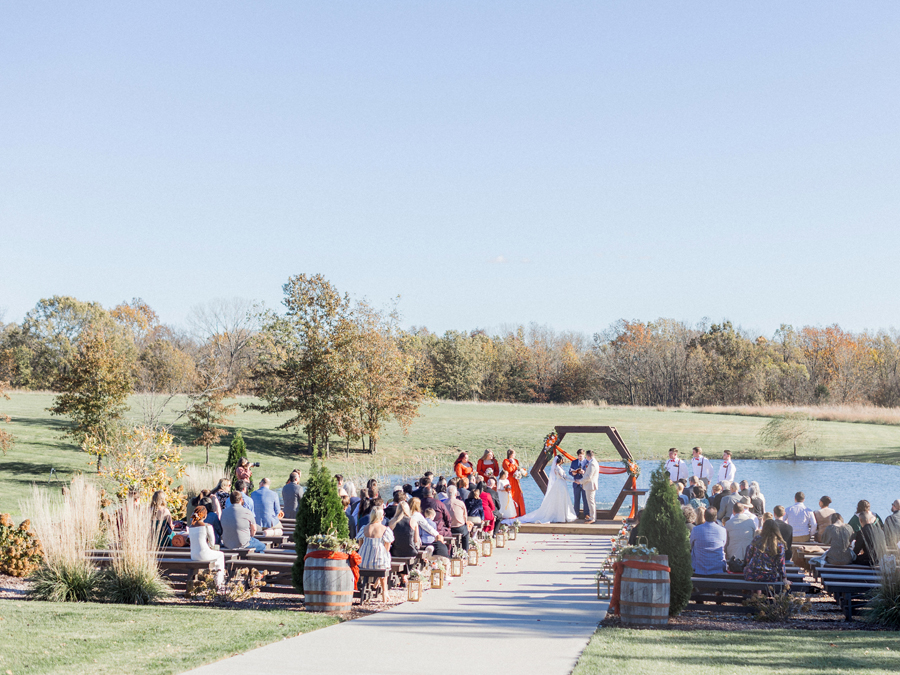 Outdoor ceremony setup with vibrant fall colors at Cooper's Ridge Wedding Venue, photographed by Love Tree Studios.