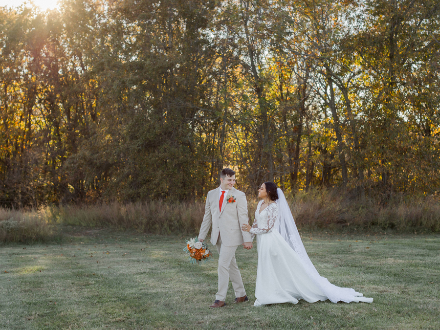 Bryanna’s stunning lace gown and Chase’s light beige suit at Cooper's Ridge Wedding Venue, captured by Love Tree Studios.