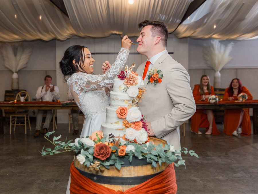 Heartfelt cake cutting at Cooper's Ridge Wedding Venue in Boonville, Missouri, captured by Love Tree Studios.