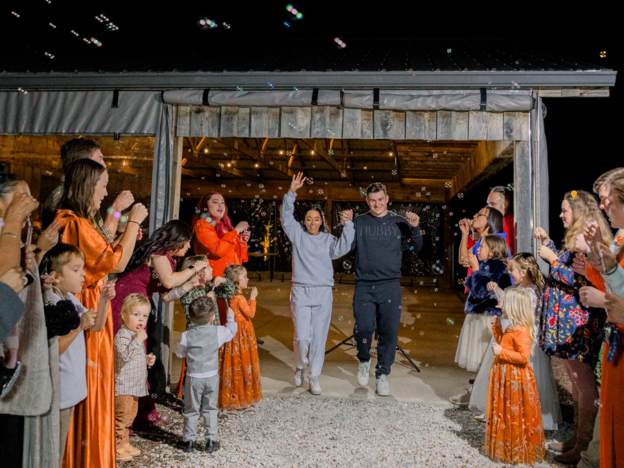 Bryanna and Chase surrounded by family and friends at Cooper's Ridge Wedding Venue, photographed by Love Tree Studios.