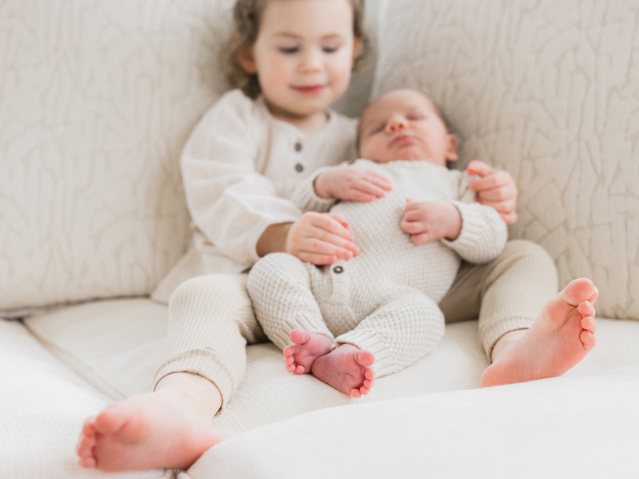 Sibling love shines as Millie embraces her newborn brother Harry in Columbia Missouri Newborn Photography - Love Tree Studios.