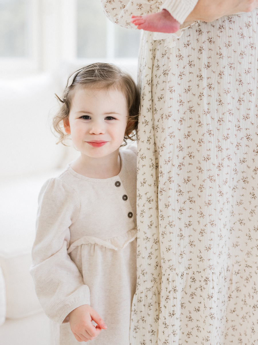 Big sister Millie proudly shows off her new baby brother during their Columbia Missouri newborn session - Love Tree Studios.